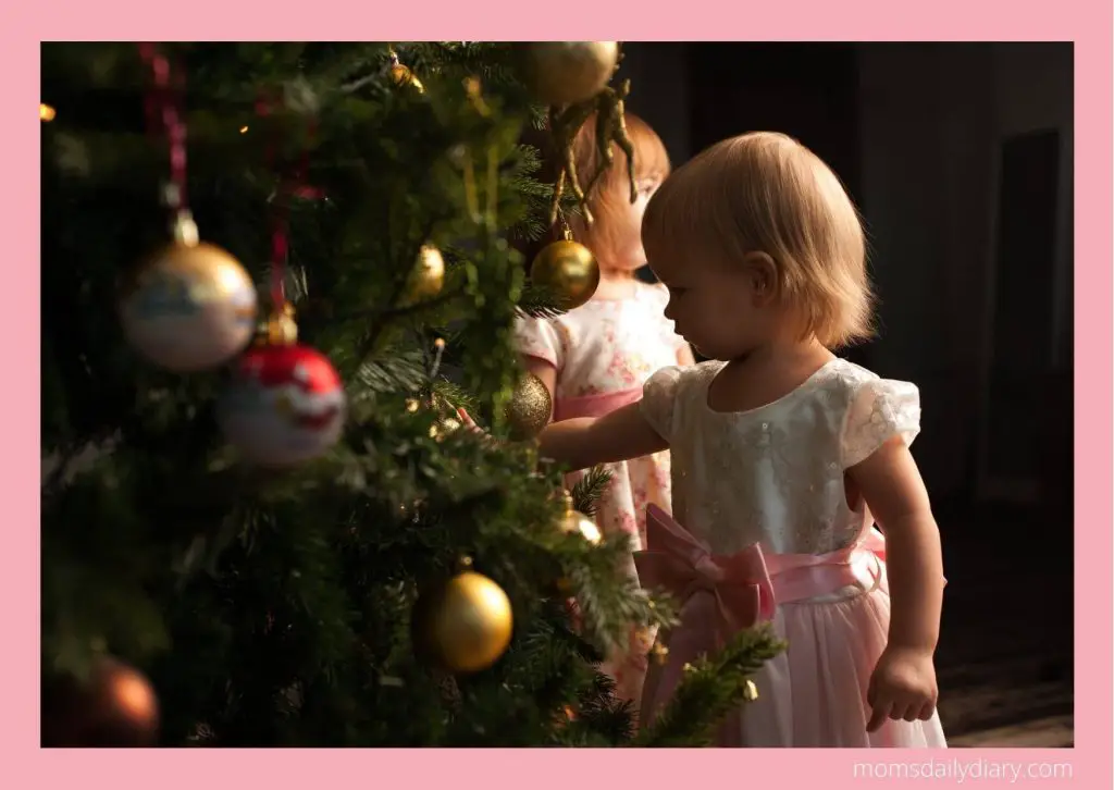 Toddler admiring the Christmas tree.