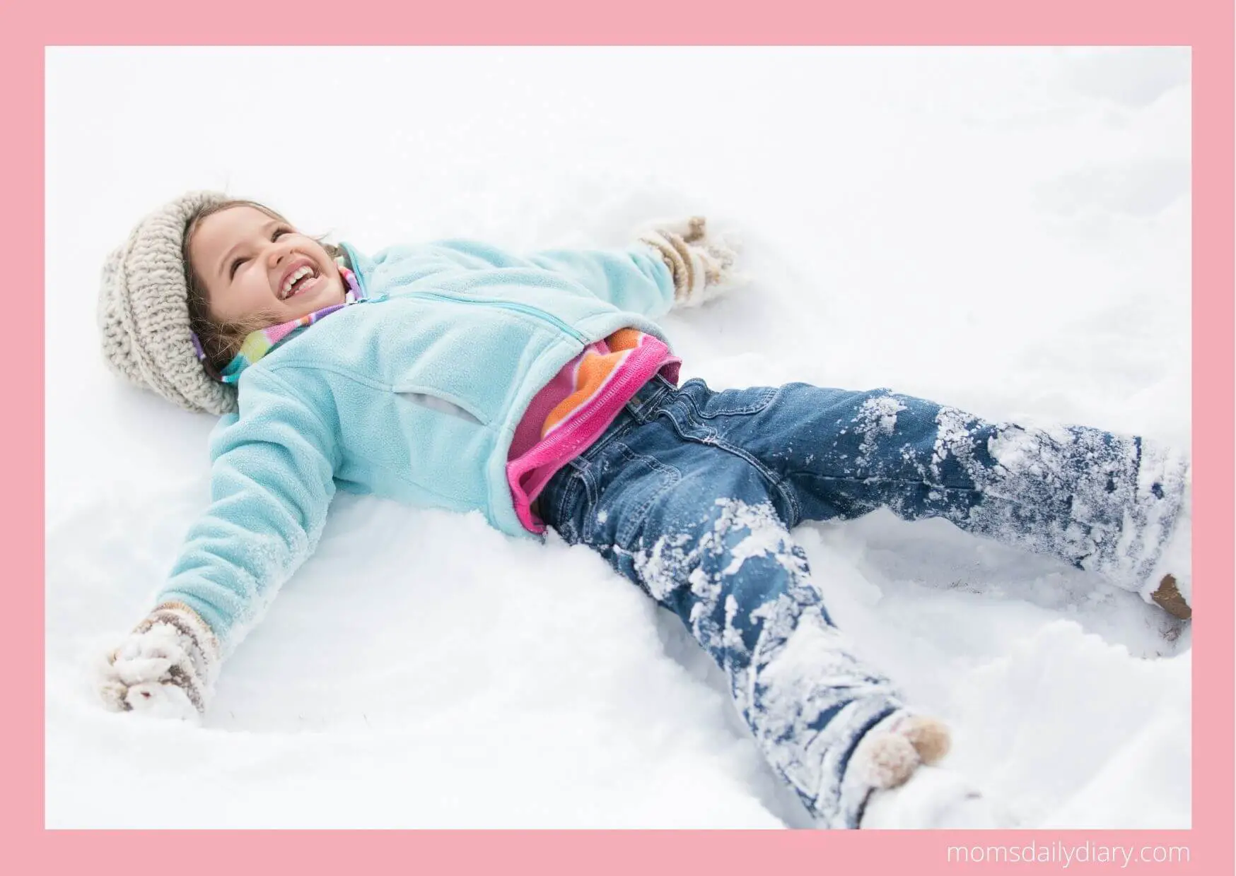 Winter activities: Toddler making a snow angel.